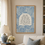 Living room with a beige armchair, floral pillow, and framed artwork on the wall.
