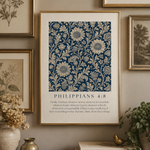 Framed floral pattern with text on a wall with other framed pictures and decor.
