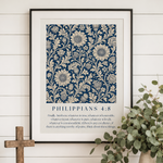Framed artwork with floral design and text on a wall above a wooden console table with decor items.