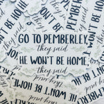 A pile of white die-cut stickers with the phrase 'GO TO PEMBERLEY, they said HE WON'T BE HOME,' in navy blue text with small green floral accents, arranged on a light wood surface.