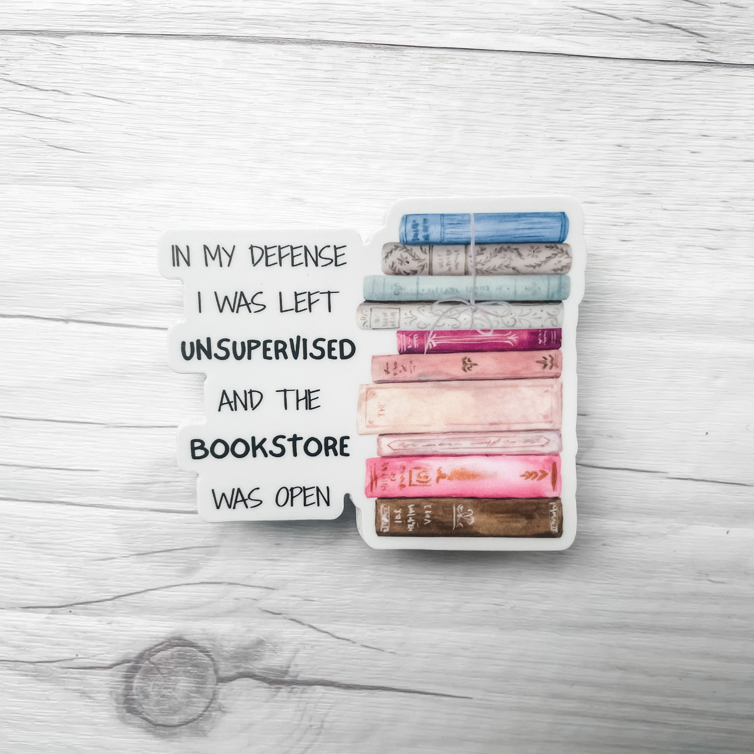 Stack of books with a humorous message on a wooden surface