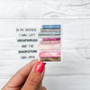 Sticker with a stack of books the the quote "in my defense i was left unsupervised and the bookstore was open"