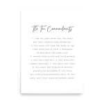 A minimalist white print featuring 'The Ten Commandments' in dark gray text, centered on a clean white background with a soft drop shadow.