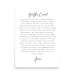 A minimalist white print featuring the Apostles Creed in elegant black typography, centered on a clean white background with a subtle drop shadow.