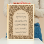 Person holding a framed print with text on a beige background