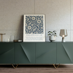 Modern interior with a green cabinet, decorative items, and a framed poster on the wall.