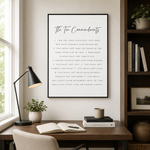 A framed wall art print featuring 'The Ten Commandments' in black text on a white background, hanging in a styled home office setting with a desk, lamp, plants, and bookshelves.